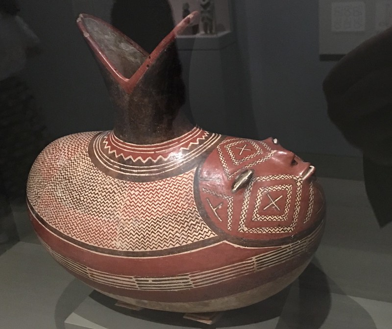  Elliptical bottle depicting a sprouting bean with a human face. 300-100 BC, Mexico